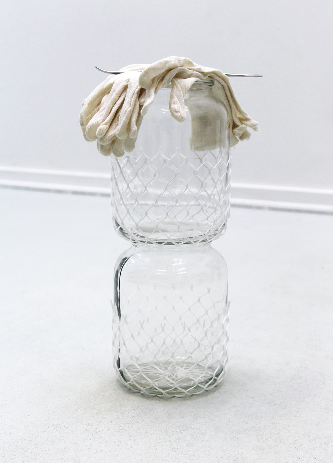 Gather, 2017, glass jars, protective sleeves, used cotton gloves, burnisher, cm. 48 x 20 x 20